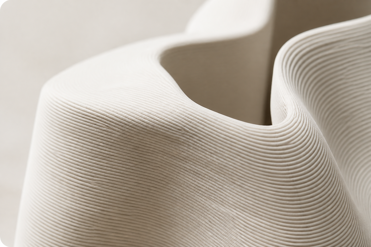 Close-up of a softly curved, digitally fabricated form with visible 3D-print layers